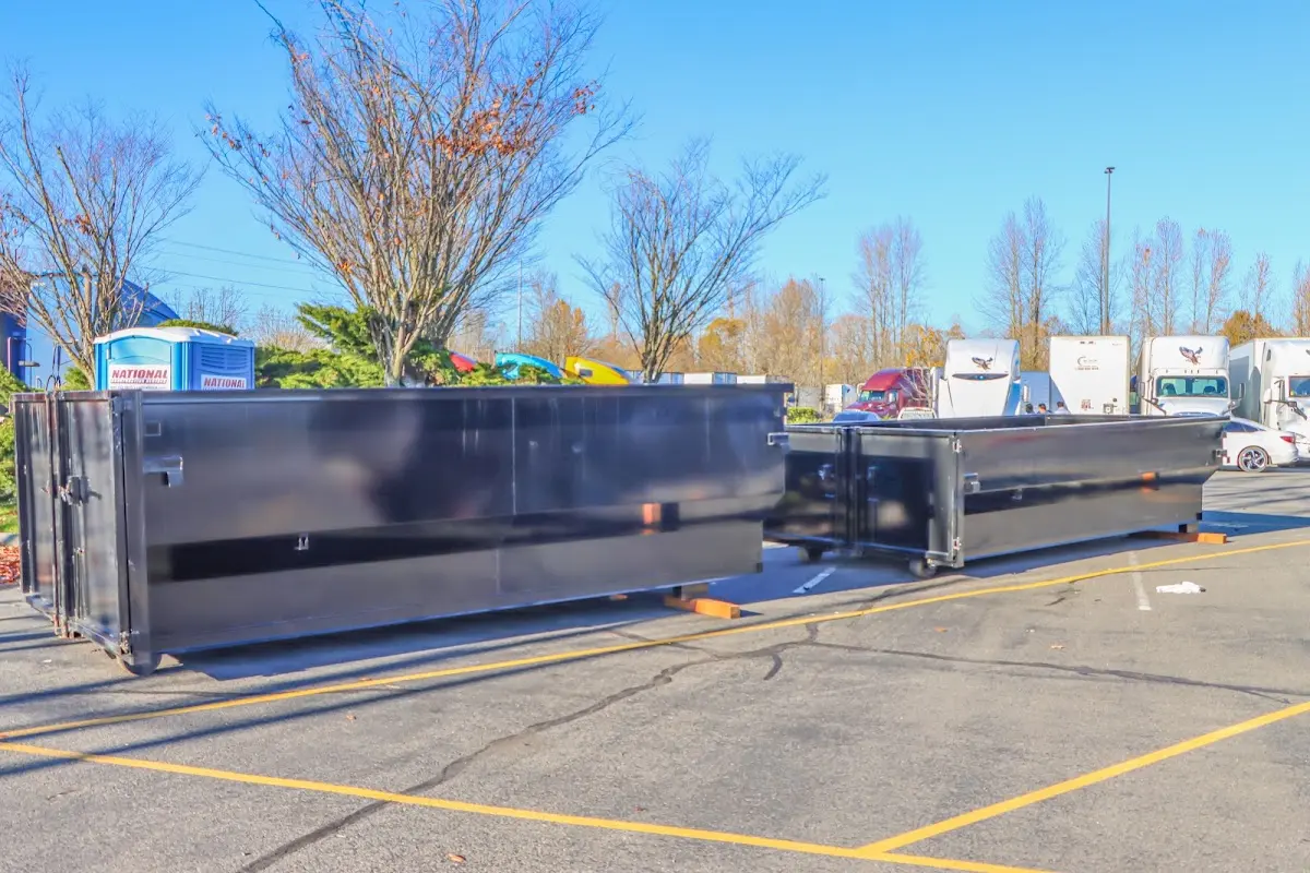 Professional dumpster rental service with roll-off container on residential driveway in Yankton